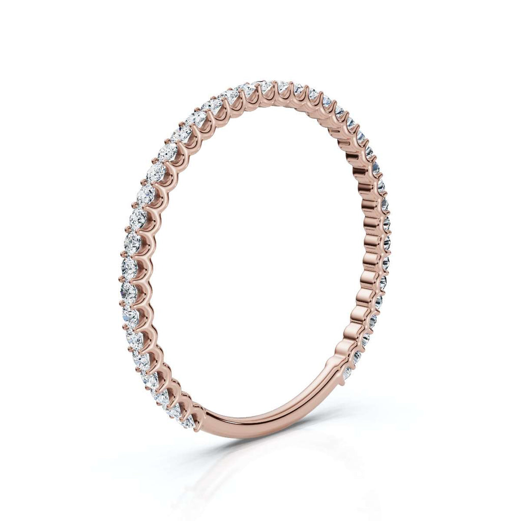 Rose gold ring with diamonds on a white background
