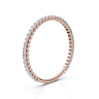 Rose gold ring with diamonds on a white background