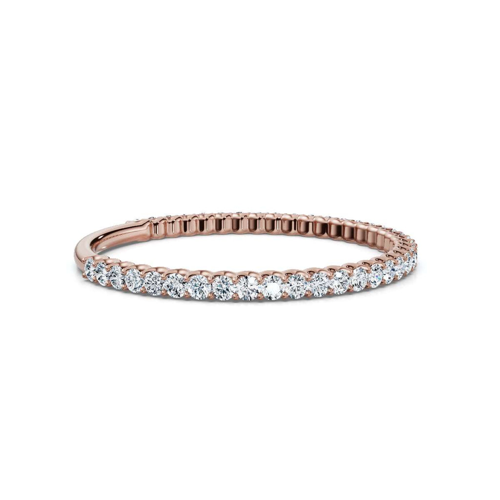 Rose gold ring with diamonds on a white background