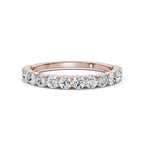 Rose gold ring with diamonds on a white background