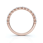 Rose gold ring with diamonds on a white background