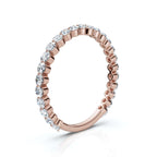 Rose gold ring with diamonds on a white background