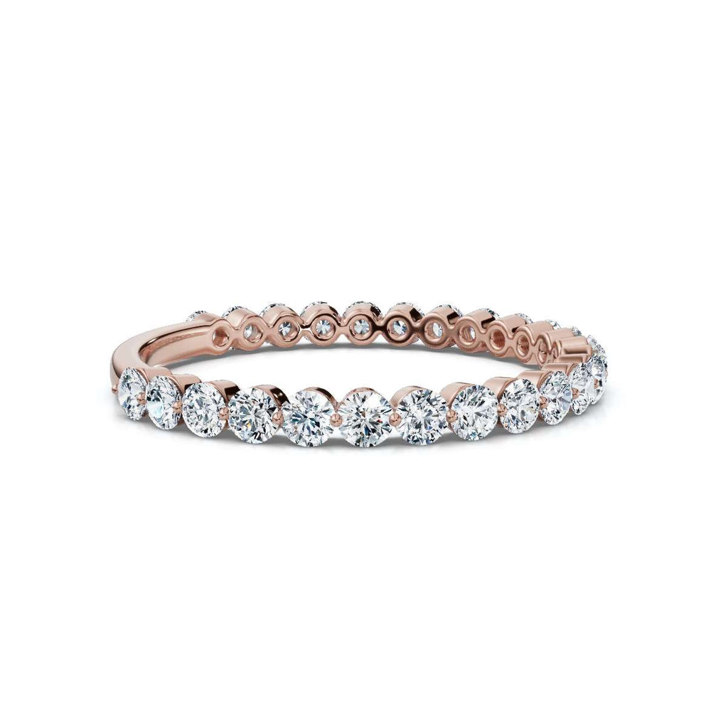 Rose gold and diamond eternity ring on a white background