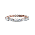 Rose gold and diamond eternity ring on a white background