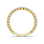 Gold ring with embedded diamonds on a white background