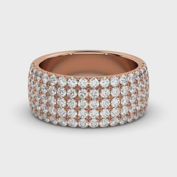 Diamond ring with multiple rows of sparkling stones on a red gold background
